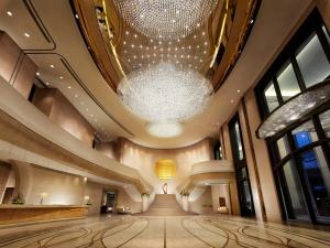 a large chandelier hangs from the ceiling of a building at Harbour Grand Hong Kong in Hong Kong