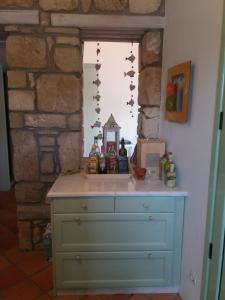 a blue dresser in a room with a window at Absolute Matala in Matala