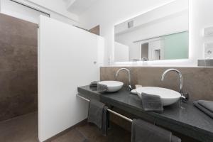 a bathroom with two sinks and a mirror at eifel5star - Burgfriedstraße in Daun