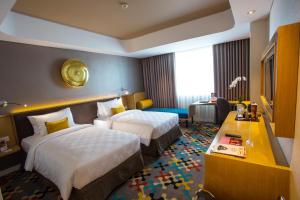 Hotel Ciputra Cibubur managed by Swiss-Belhotel International客房内的一张或多张床位