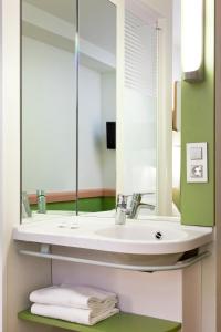 a bathroom with a sink and a mirror at ibis budget Alicante in Alicante