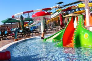 a boy playing on a water slide at a water park at Spring Hotel in Novxanı