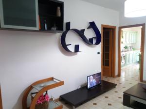 a living room with a tv on a wall at Casa Marilù in Alghero