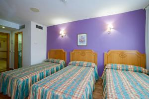 Postel nebo postele na pokoji v ubytování Hotel Río Cabia