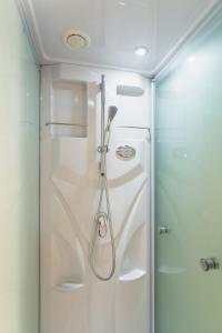 a shower in a bathroom with a glass door at Ecol Beppu in Beppu +36 photos