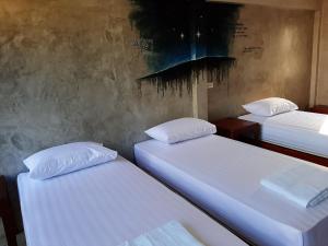 Postel nebo postele na pokoji v ubytování Baan Rabiangdao UthaiThani
