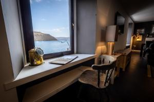 a room with a window with a desk and a chair at Bayview in Portree