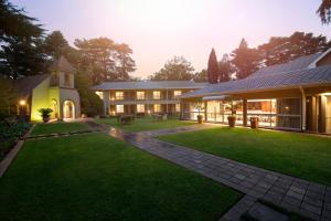 an exterior view of a house with a lawn at Three Rivers Lodge and Villas in Vereeniging