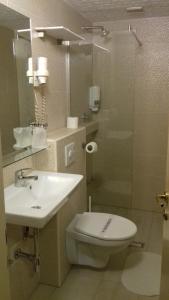 a bathroom with a sink and a toilet and a shower at B&B Boem in Požarevac
