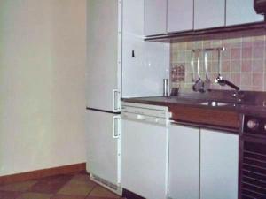 a kitchen with a white refrigerator and a sink at Bordighera centro molto tranquillo in Bordighera