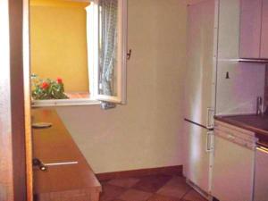a kitchen with a refrigerator and a window at Bordighera centro molto tranquillo in Bordighera +8 photos
