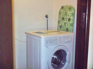a white washing machine in a corner of a room at Bordighera centro molto tranquillo in Bordighera