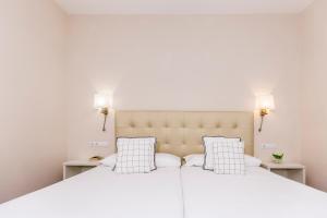 two beds in a bedroom with two lamps on both sides at Hotel Madrid in Las Palmas de Gran Canaria +31 photos
