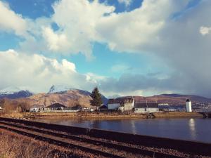 a view of a town with a river and mountains at Hawthorn Lodge in Fort William