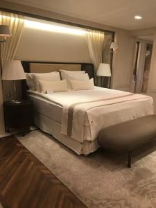 a bedroom with a large bed and two lamps at Kemer Country Hotel İstanbul in Istanbul