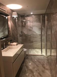 a bathroom with a shower and a toilet and a sink at Kemer Country Hotel İstanbul in Istanbul