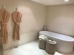 a bathroom with a bath tub and a toilet at Kemer Country Hotel İstanbul in Istanbul