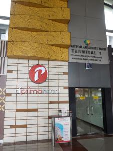 a sign on the side of a building at d'primahotel Airport Jakarta Terminal 1A in Tangerang