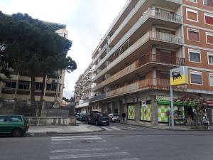 a street with cars parked in front of a building at B&B RELAX in Messina