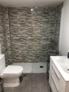 a bathroom with a toilet and a sink at MISTRAL 17 in El Campello +7 photos