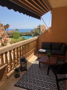 a balcony with a couch and a table on a balcony at MISTRAL 17 in El Campello