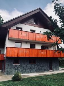 a building with a balcony on top of it at Guest house Kobal in Zgornje Gorje