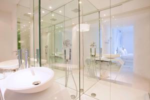 a bathroom with a sink and a glass shower at Blc Design Hotel in Paris +54 photos