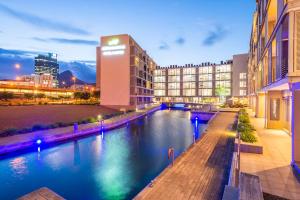 vista para um rio em uma cidade à noite em aha Harbour Bridge Hotel & Suites em Cidade do Cabo