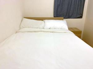 מיטה או מיטות בחדר ב-The Cove Hostel - Tong Fuk Sea Lion