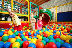 three children playing in a large pile of balls at Martı Myra - Ultra All Inclusive in Tekirova
