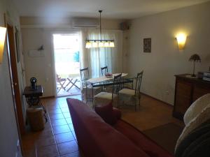 a living room with a table and a dining room at Mas Pinell 129 in Torroella de Montgrí