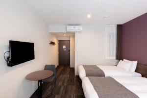 En eller flere senger på et rom på M's Hotel Gojo Naginatagiri