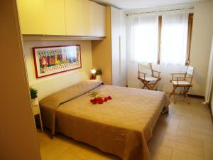 a bedroom with a bed with flowers on it at Appartamento La Croma in Grado