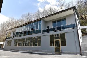 an office building with large windows on the side at GreenWood Hotel in Dilijan
