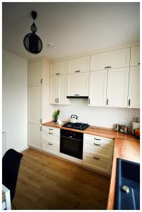 a kitchen with white cabinets and a stove top oven at Color 24 Premium in Stalowa Wola