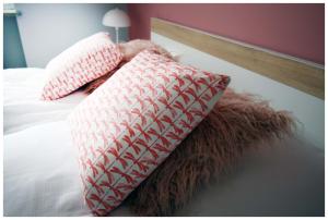 two pillows sitting on top of a bed at Color 24 Premium in Stalowa Wola