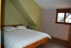 a bedroom with a bed with white sheets and a window at LE LOFT in Wintzenheim +24 photos