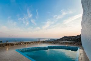 a swimming pool with a view of the ocean at Anemolia Villa in Karpathos