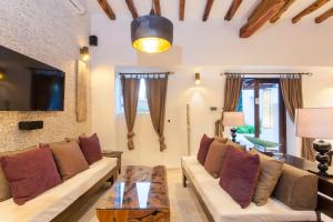 a living room with a couch and a table at Ibiza luxury villa in Santa Eularia des Riu