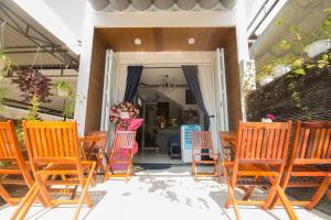 a group of chairs and tables on a patio at Lagoon Homestay Hoi An in Hoi An