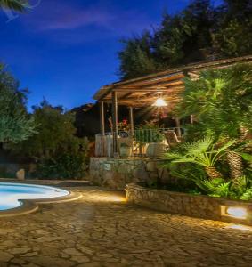 a house with a swimming pool at night at Villa Adriana - Torre delle Stelle - mini appartamenti - Cagliari Villasimus Sardegna in Torre delle Stelle