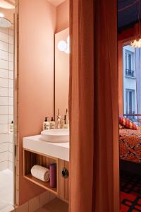 a bathroom with a sink and a mirror at 25hours Hotel Terminus Nord in Paris