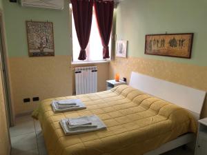 Postel nebo postele na pokoji v ubytování B&B Quattro Palazzi Napoli Centro