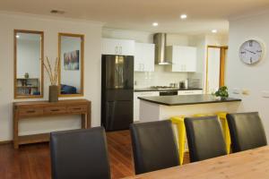 a kitchen and dining room with a table and chairs at 12 Mount Porepunkah Road in Bright