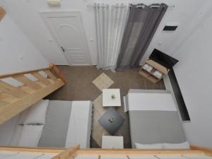 an overhead view of a living room with a staircase at Frezia Complex - Frezia Apartments in Nea Potidaea