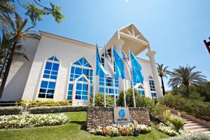 a building with a sign in front of it at Grupotel Parc Natural & Spa in Playa de Muro