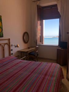Postel nebo postele na pokoji v ubytování VisitPonza - Le Stanze Sulla Spiaggia