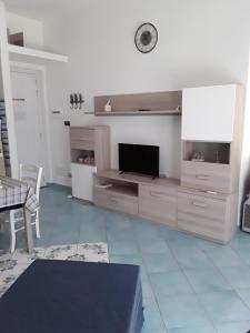 a living room with a flat screen tv on a wall at MARGIE'S HOUSE in Procida