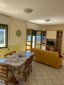 a living room with a table and a couch at House Joseph in Ravello