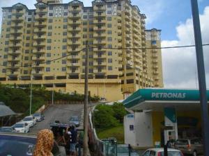 una stazione di servizio di fronte a un grande edificio di Tenang & Tranquil Homestay - B605 Cameron Highlands a Brinchang